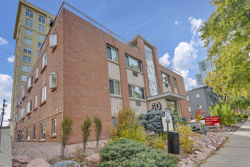 a large brick building with a sidewalk in front of it