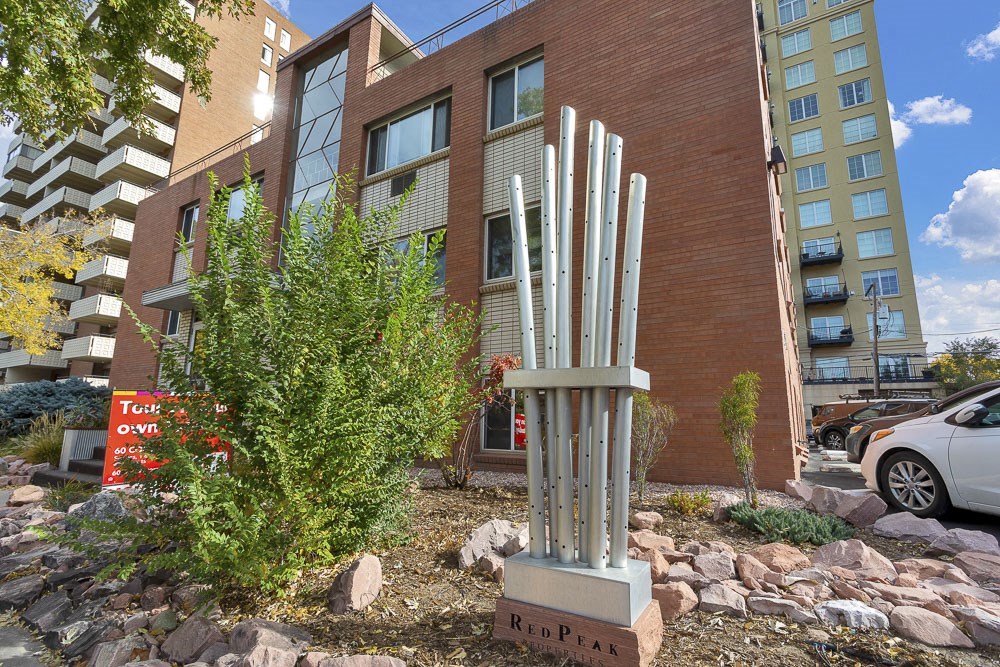 a sculpture of white poles in front of a building