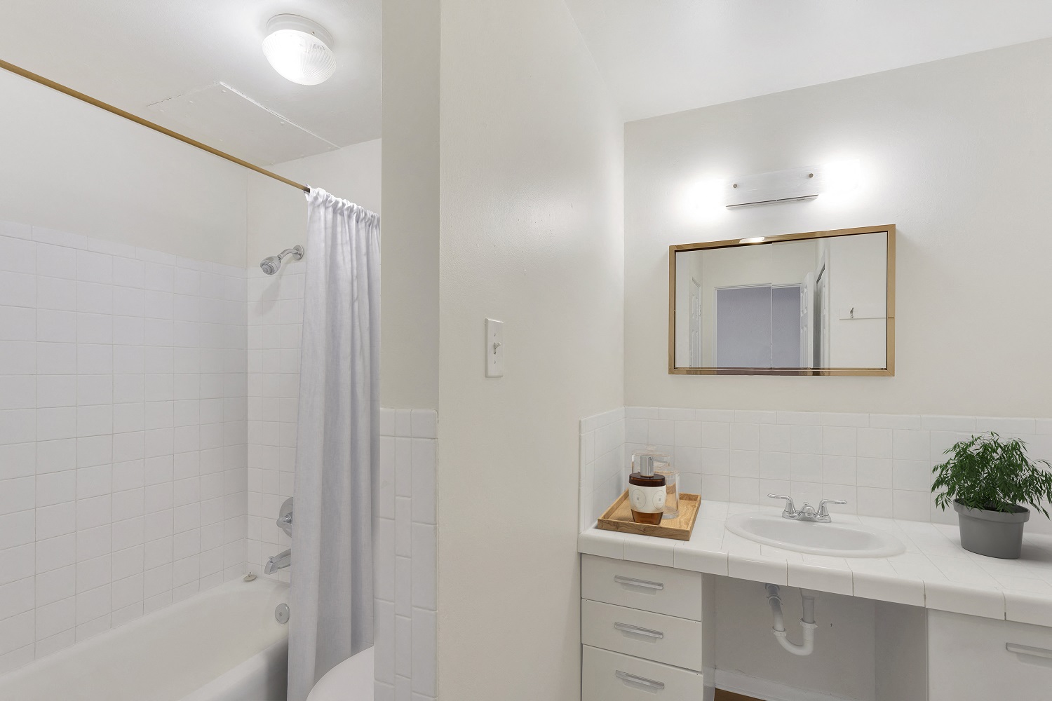 a bathroom with a shower and a sink and a mirror