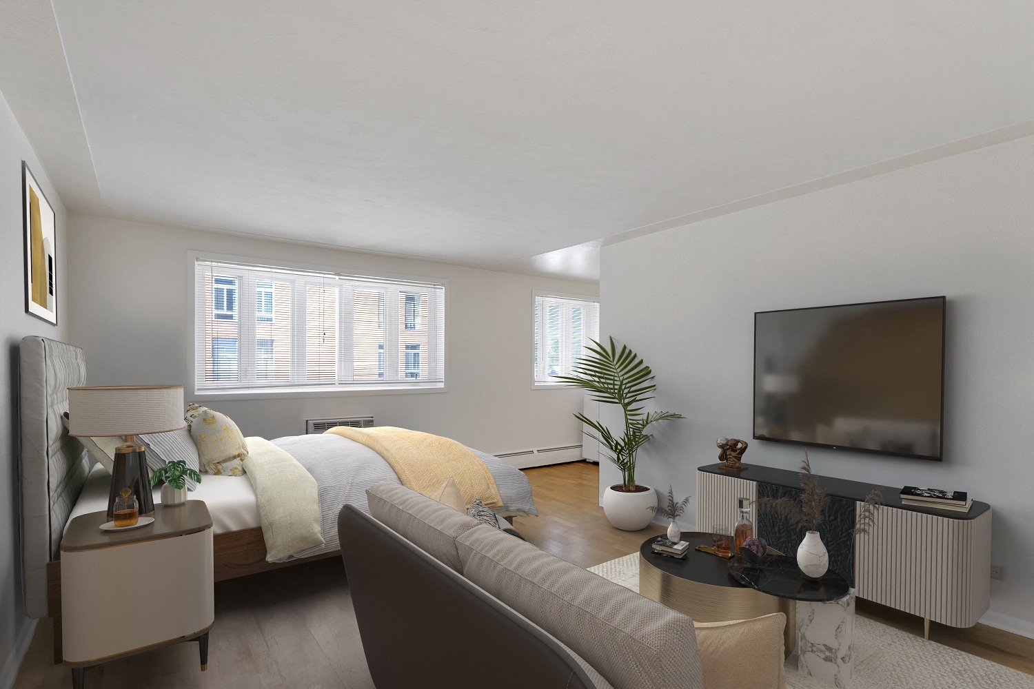 a bedroom with a couch and a bed and a tv