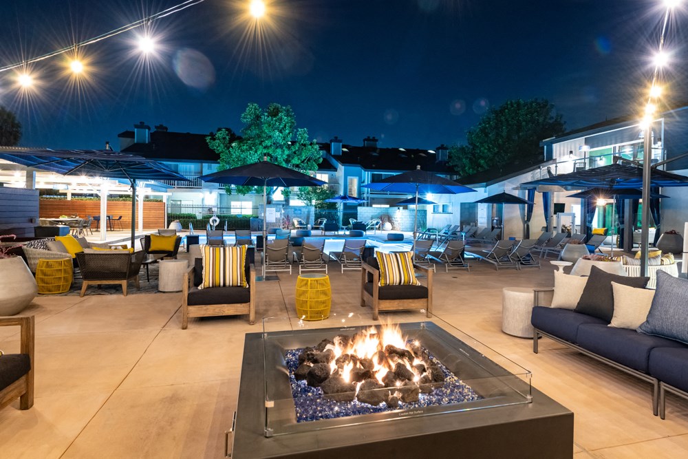 Outdoor fire pit with seating in pool area