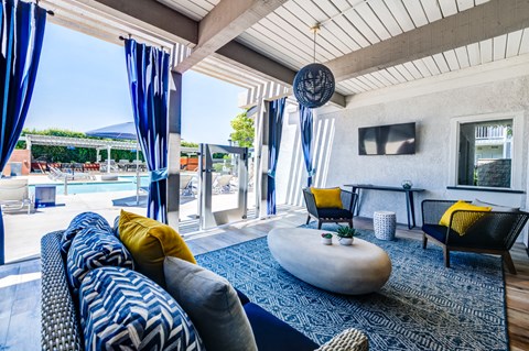 a living room with blue and yellow furniture and a pool