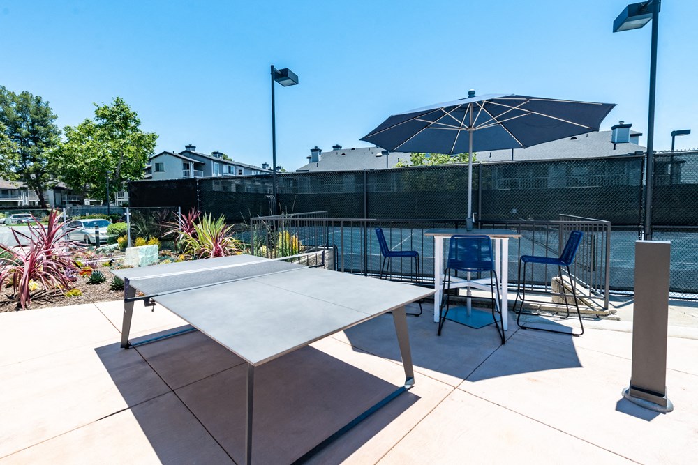 Ping pong table adjacent to tennis court