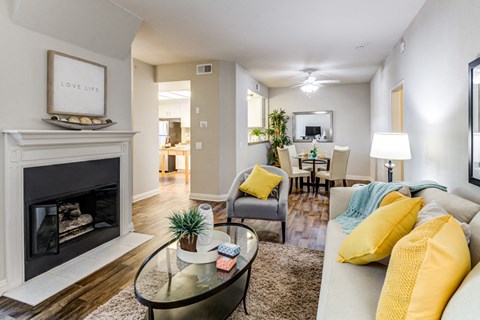 Living Room with Ceiling Fan, Fireplace, Wood-Style Floors, and View of Dining Room at Aliso Creek, Aliso Viejo, 92656