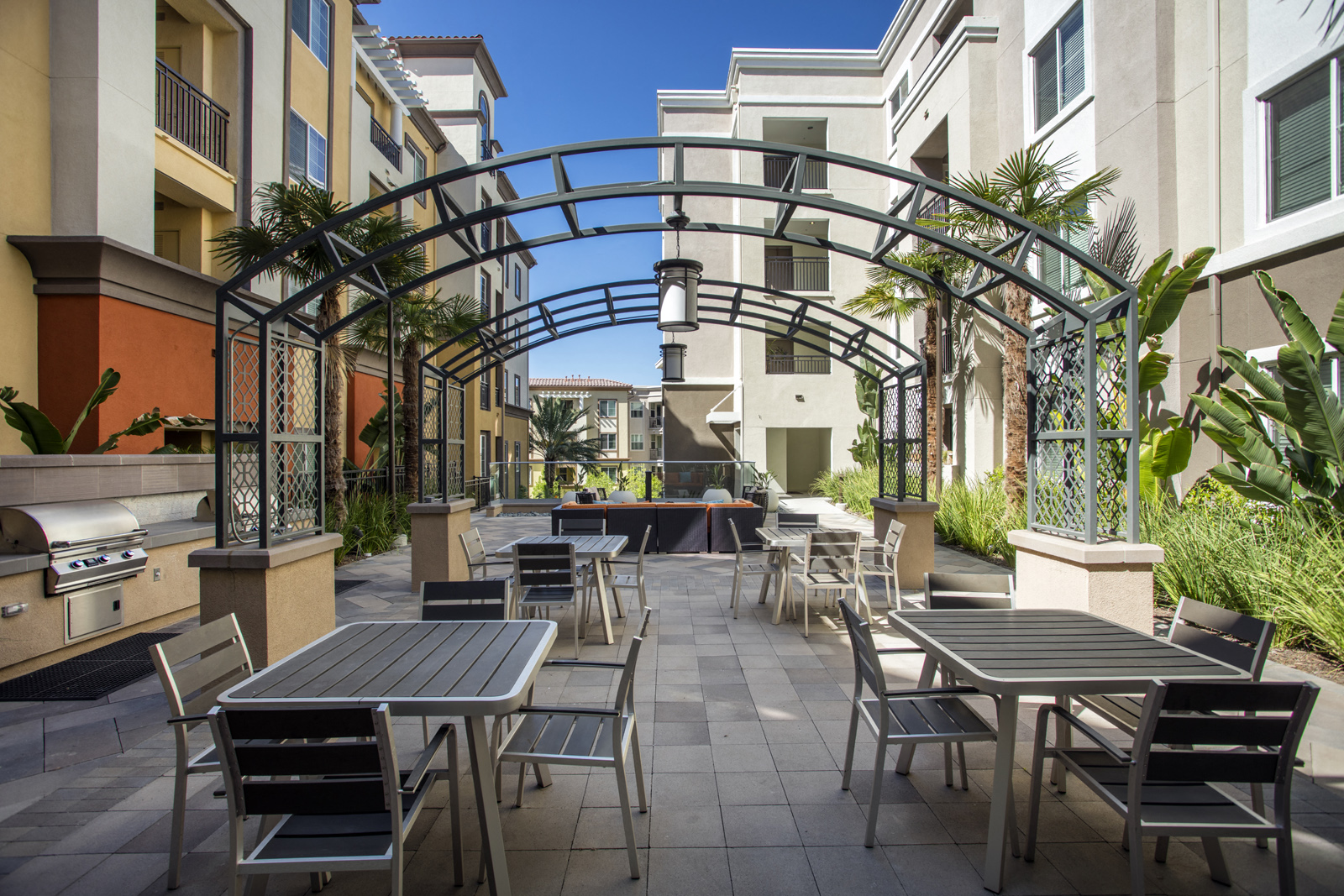 Woodland Hills CA Apartments-The Boulevard Apartments With Multiple Seating Areas And Barbeque Grills And Surrounding Plants