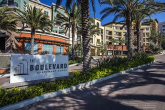 the boulevard apartments sign in front of palm trees
