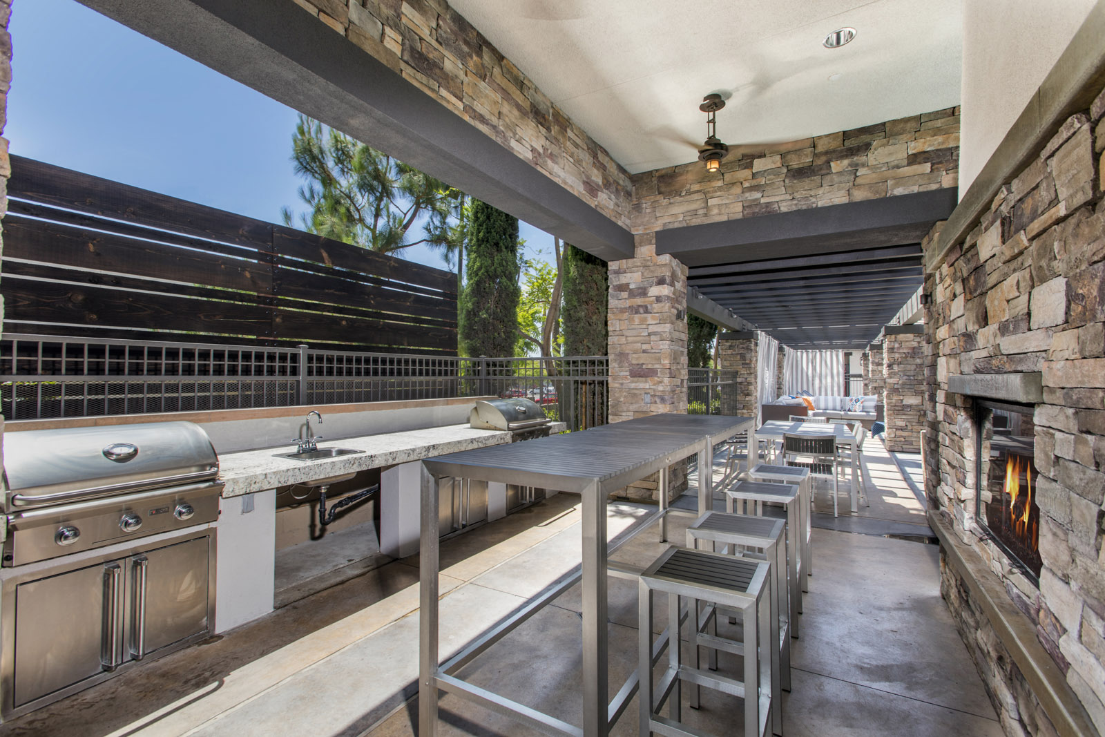Outdoor grill and seating near fireplace