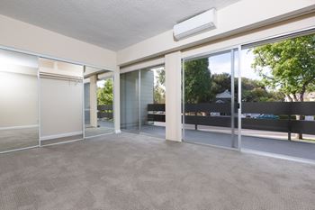 Living room with glass doors and a carpeted floor at Palo Alto Place, Palo Alto, CA, California