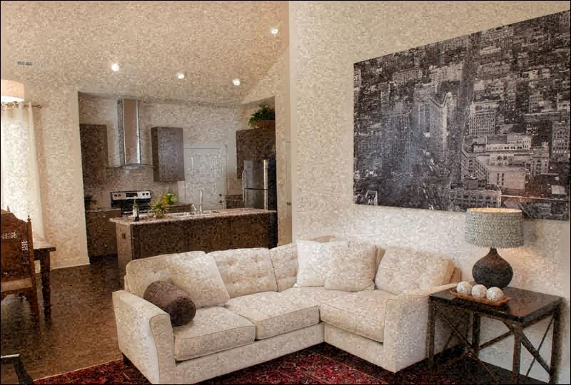 a living room with a couch and a painting on the wall