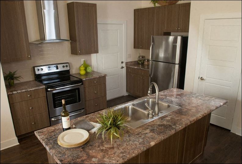 a kitchen with stainless steel appliances and a granite counter top