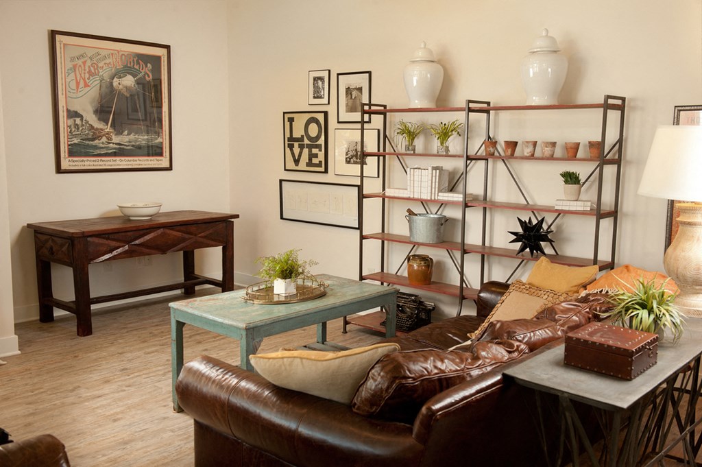 a living room with a brown leather couch and a table