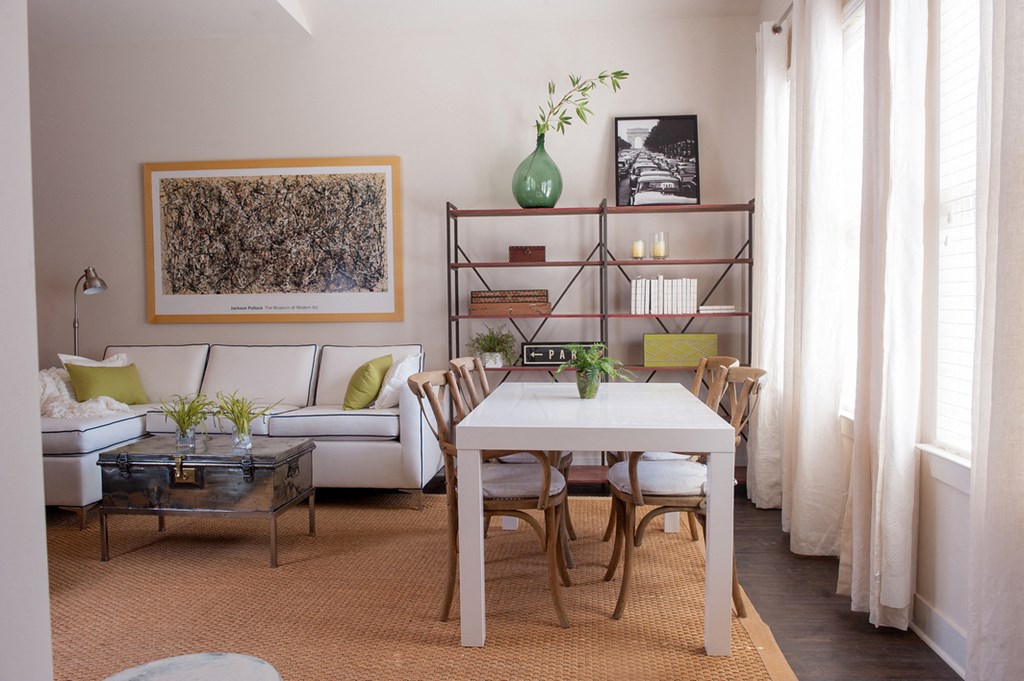 a dining room with a table and chairs and a living room