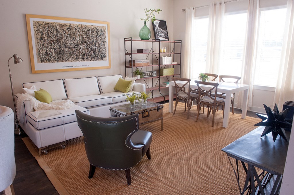 a living room with a white couch and a table and chairs