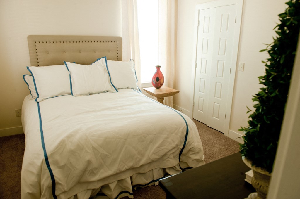 a bedroom with a large bed and a window
