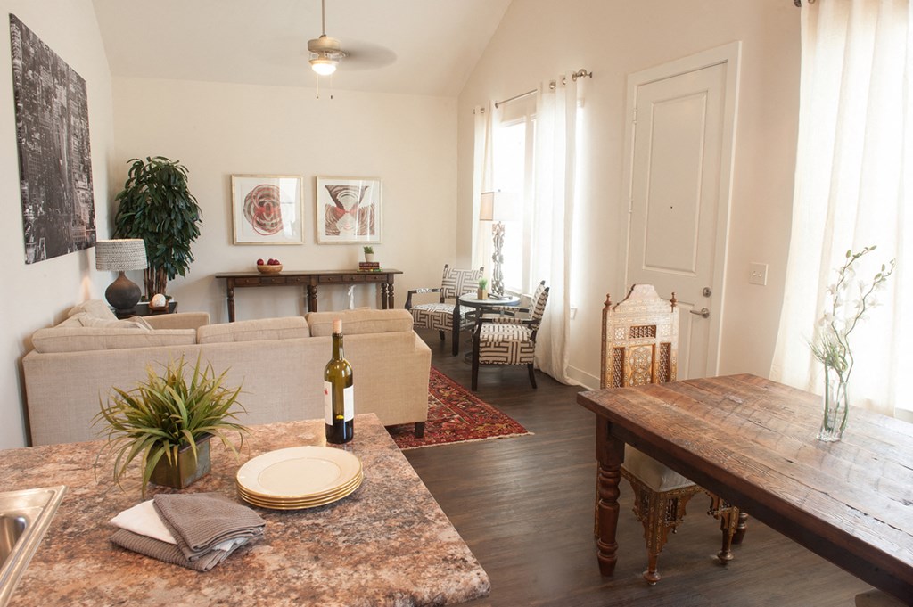 a living room with a couch and a table with a bottle of wine