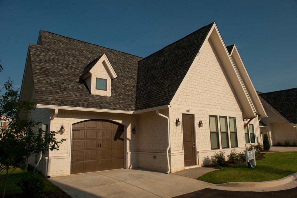 a house with a garage door in front of it