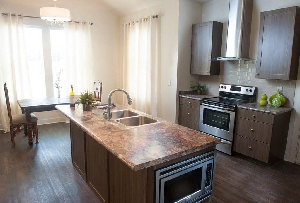 a kitchen with a marble counter top and a sink