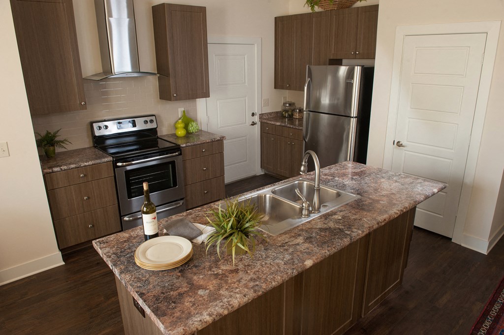 a kitchen with stainless steel appliances and granite counter tops