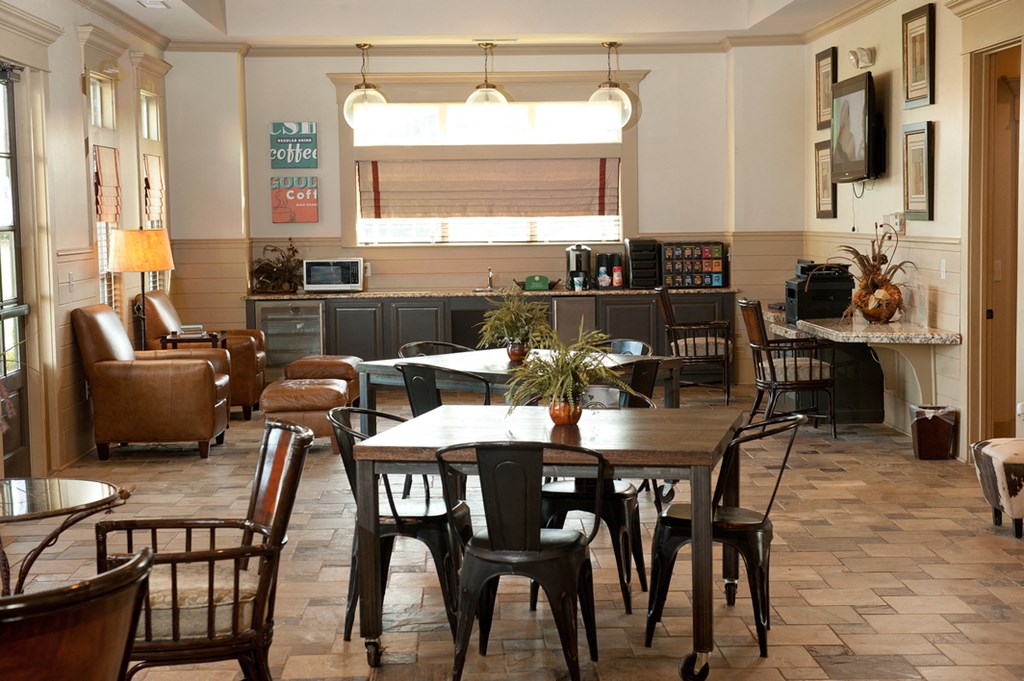 a living room with a table and chairs and a kitchen
