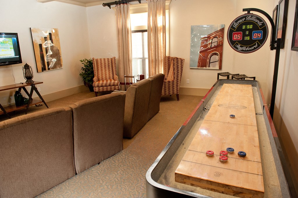 an air hockey table in a living room with couches and a tv