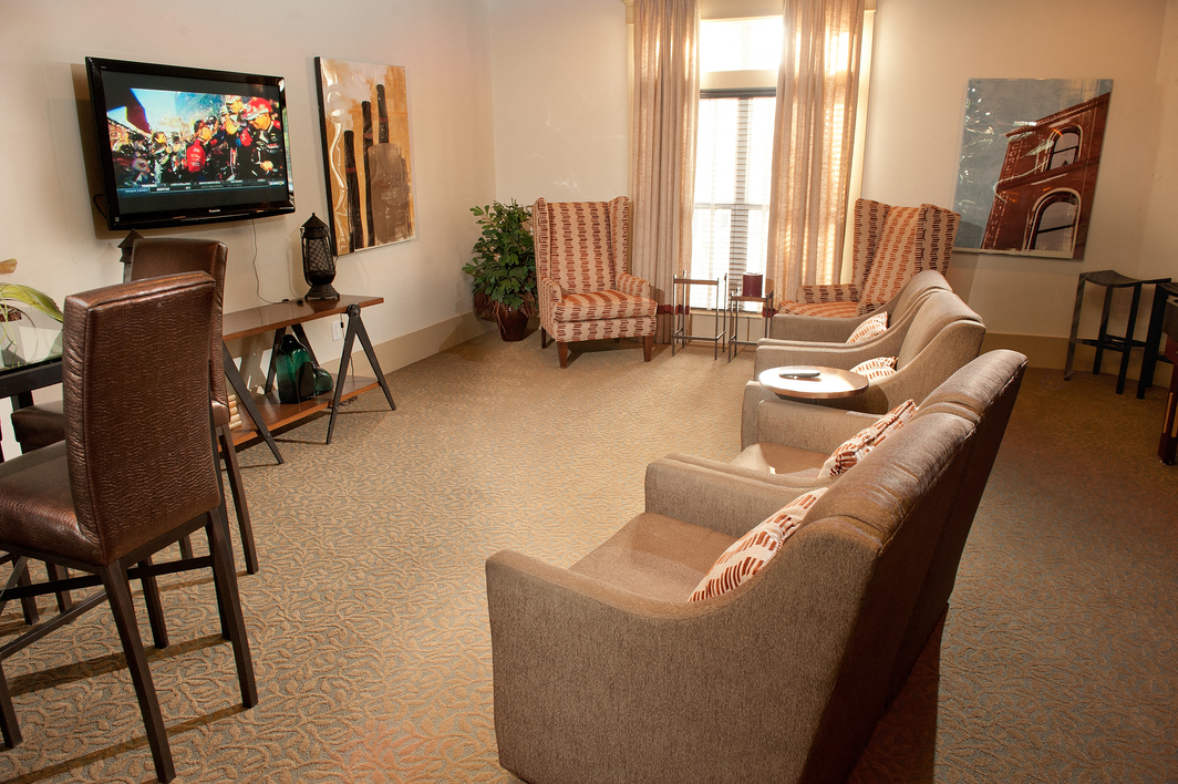 a living room with couches and chairs and a television