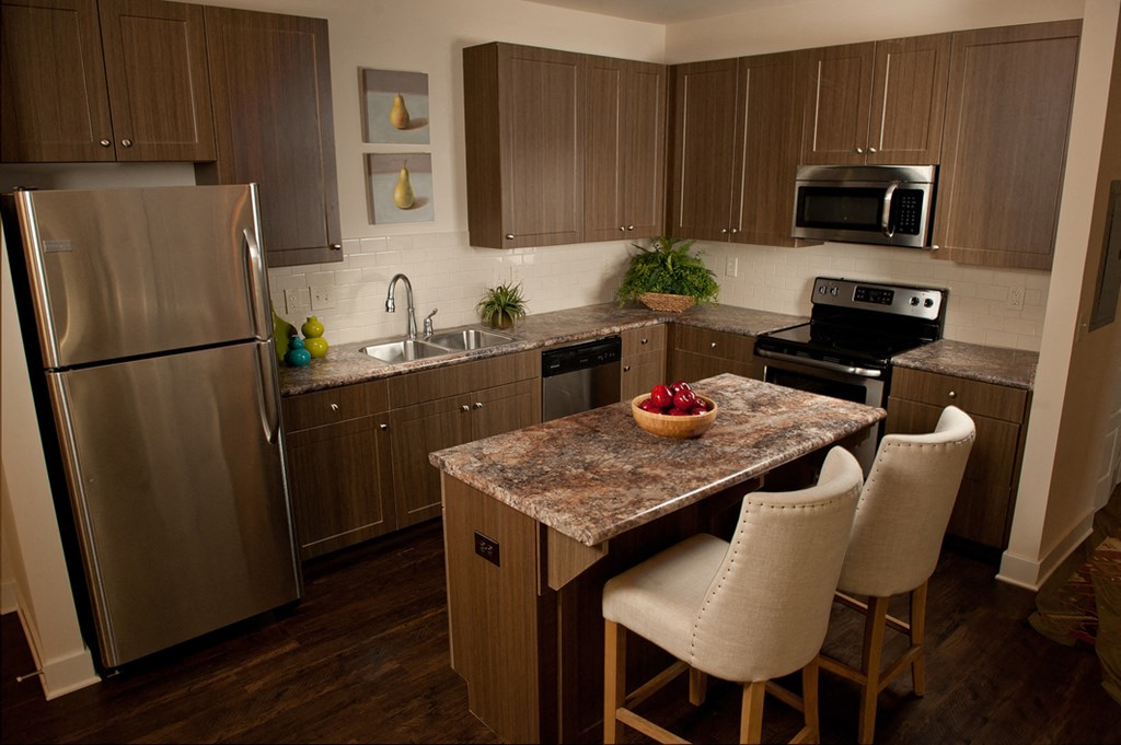 a kitchen with stainless steel appliances and a granite counter top
