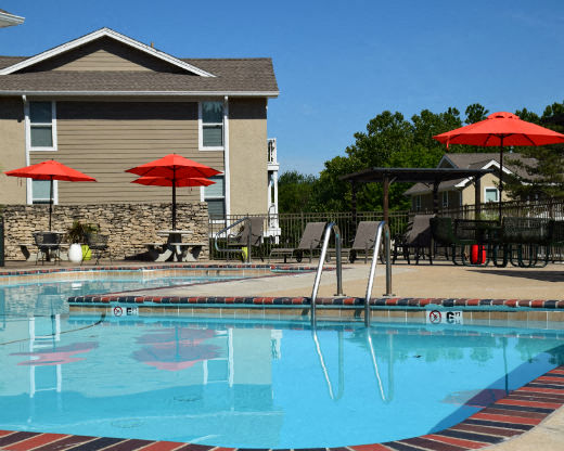 a swimming pool with umbrellas and chairs around it