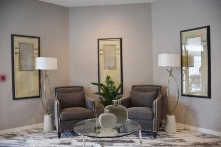 a living room with two chairs and a glass table