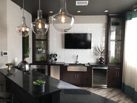 a kitchen with a sink and a tv in it