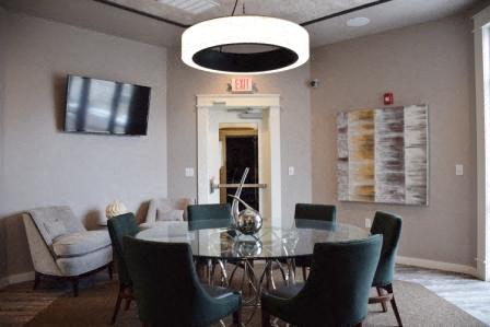 a dining room with a glass table and chairs