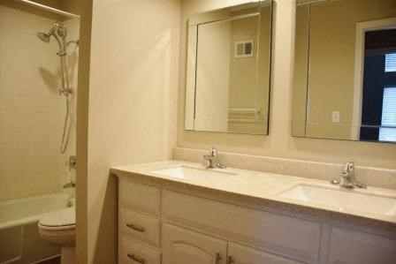 a bathroom with two sinks and a mirror