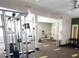 a gym with weights and other equipment in a room