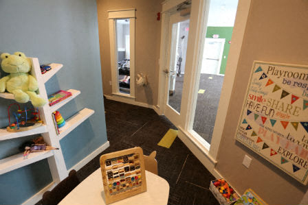 a room with a table and a hallway with doors