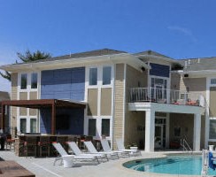 a large swimming pool in front of a house