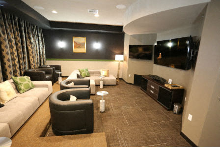 a living room with couches and chairs and a television