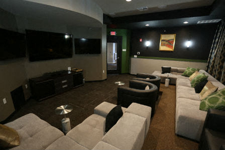 a living room with couches and chairs and a television