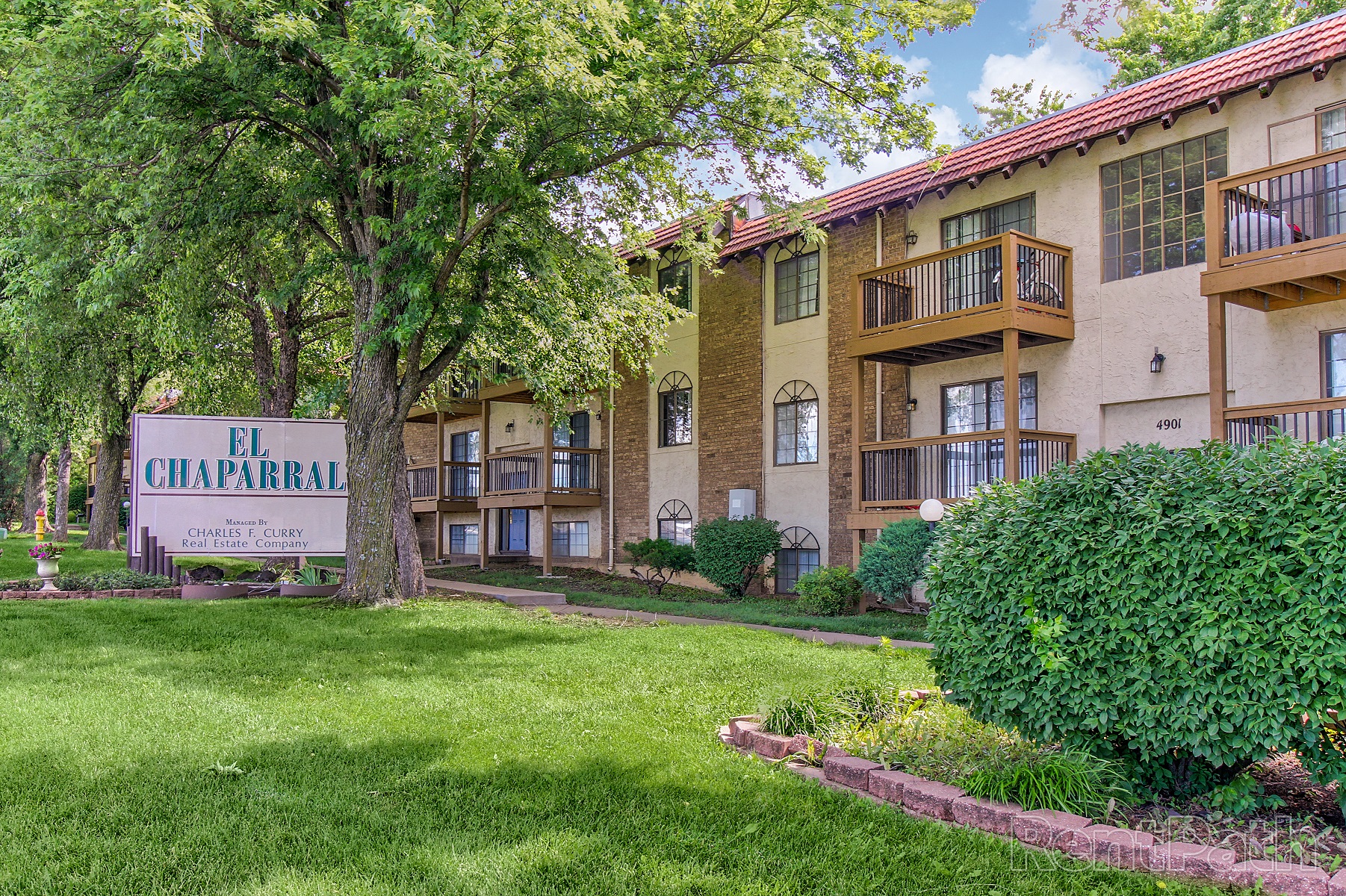 our apartments offer a green lawn and trees for residents to enjoy