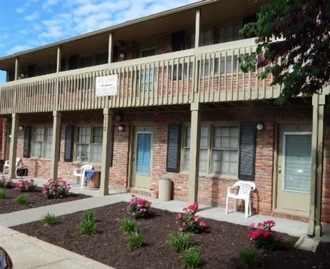 a building with a porch and a sign on the balcony