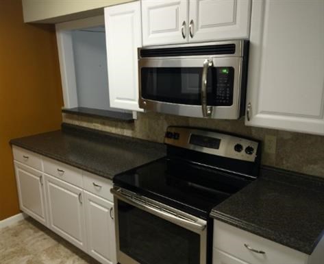 a kitchen with a stove and a microwave