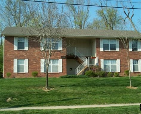 a brick house with a tree in front of it