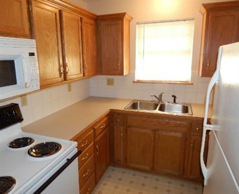 a kitchen with a stove microwave and a sink