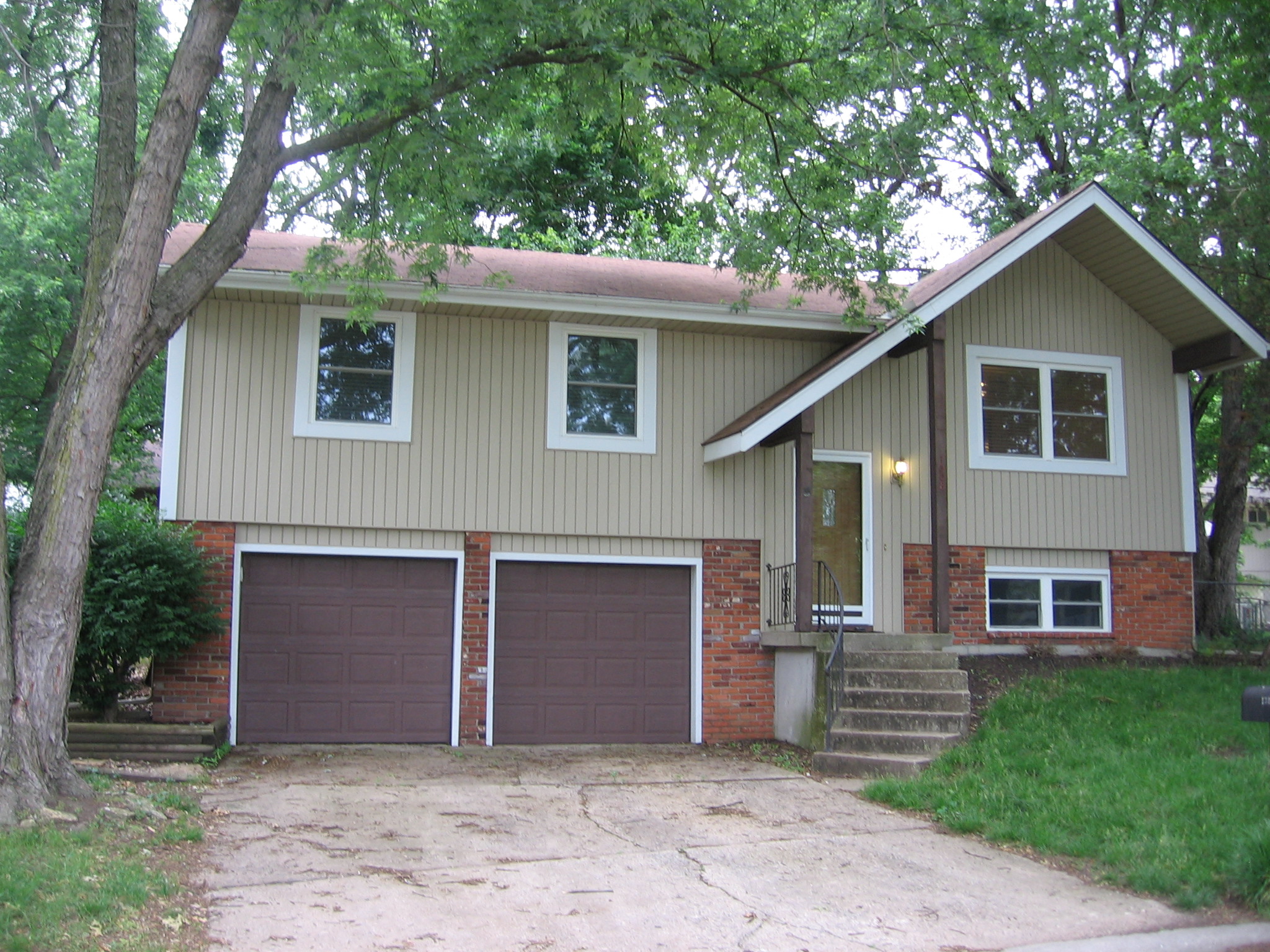 the front of a house with two garage doors