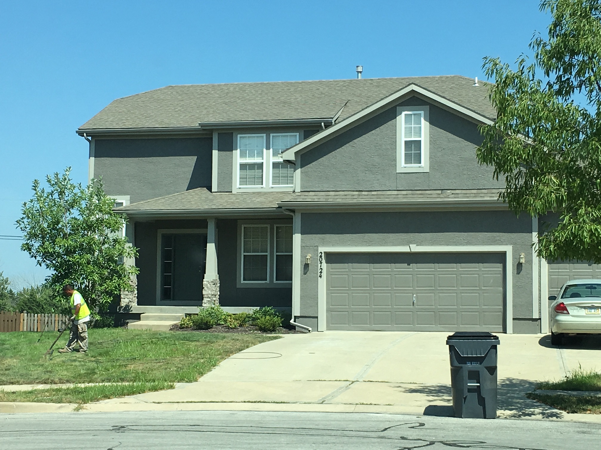 a person riding a bike in front of a house