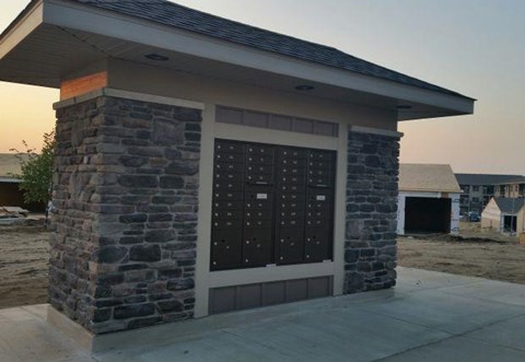 a small brick building with a garage door