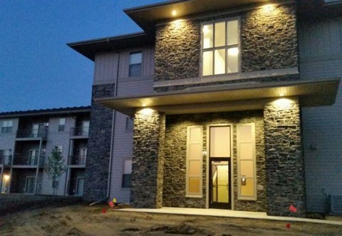 the front of a building with lights on it