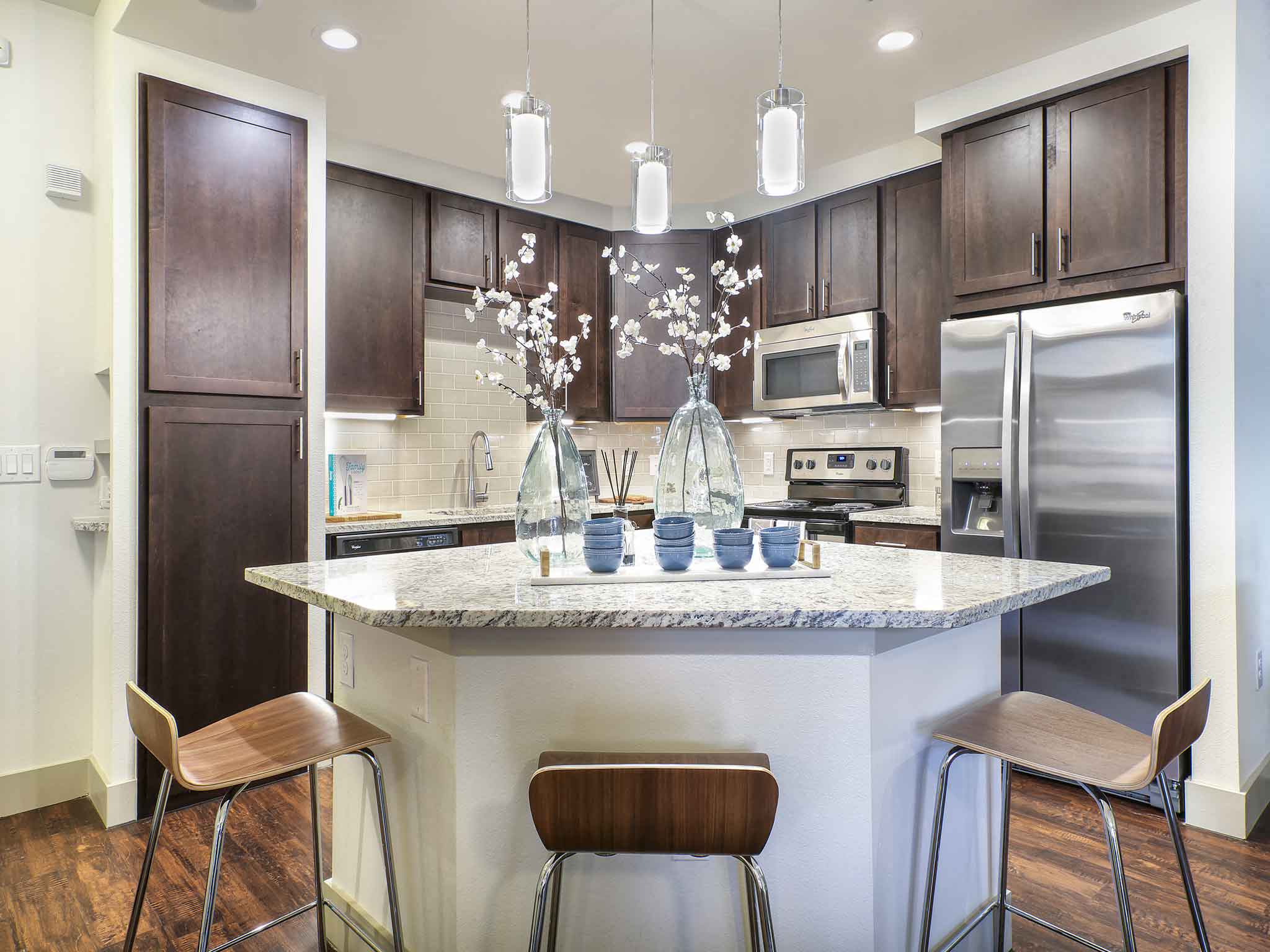 a kitchen with a marble counter top and stainless steel appliances