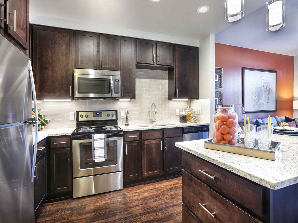 a kitchen with stainless steel appliances and wooden cabinets