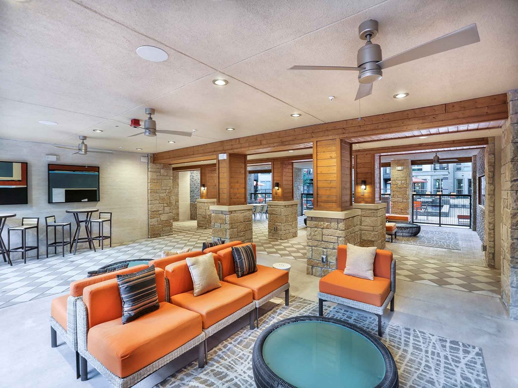 a living room with orange couches and a table