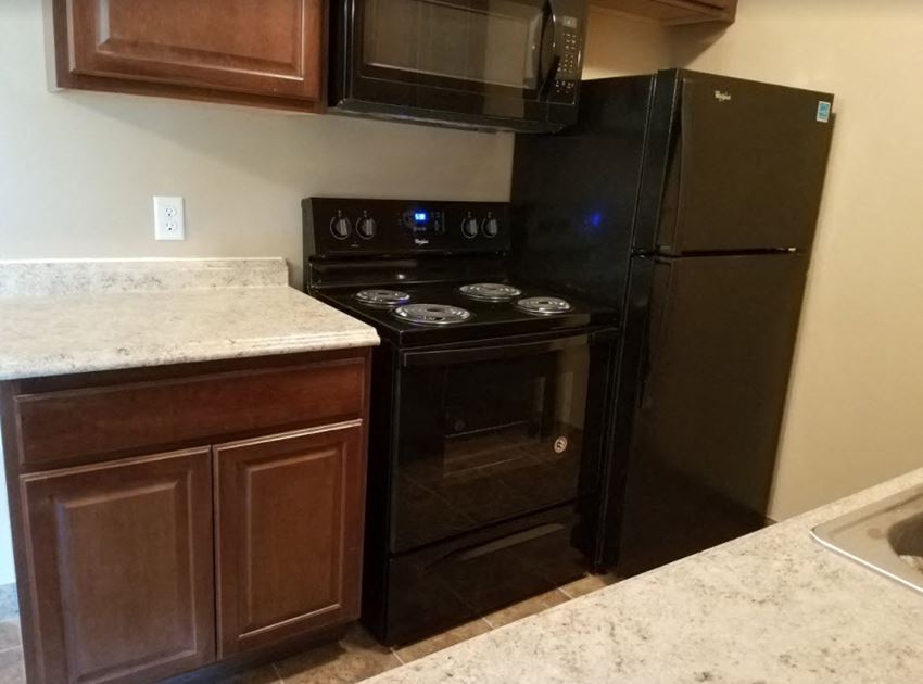 a kitchen with a stove and a refrigerator