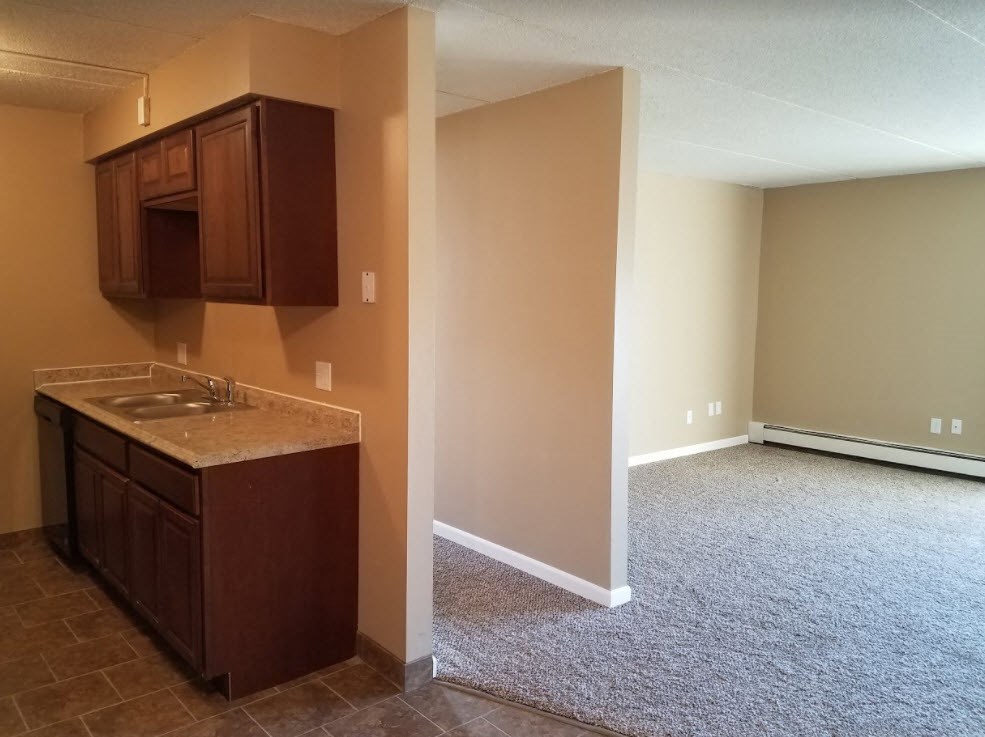 a empty room with a sink and a kitchen